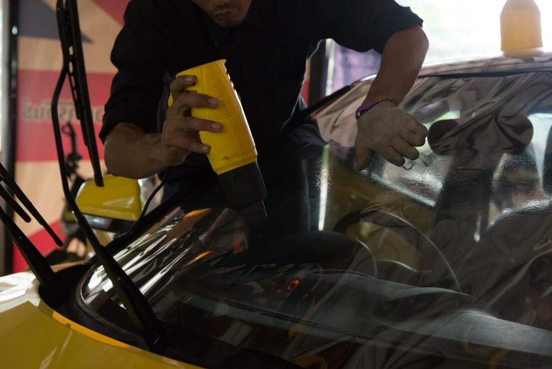 Man applying car window tint